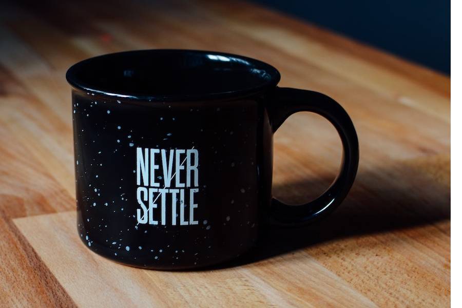 Coffee mug with Never Settle message echoes a client's testimonial