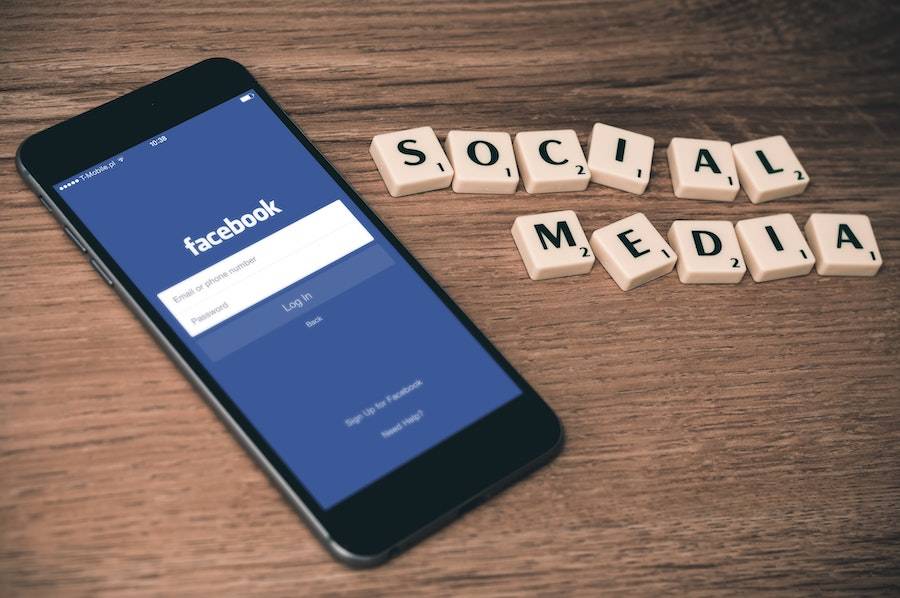 Social Media Scrabble Tiles next to Facebook on cell phone